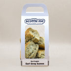 A cute white handled bag showcasing four delicious rustic scones infused with real Earl Grey tea.