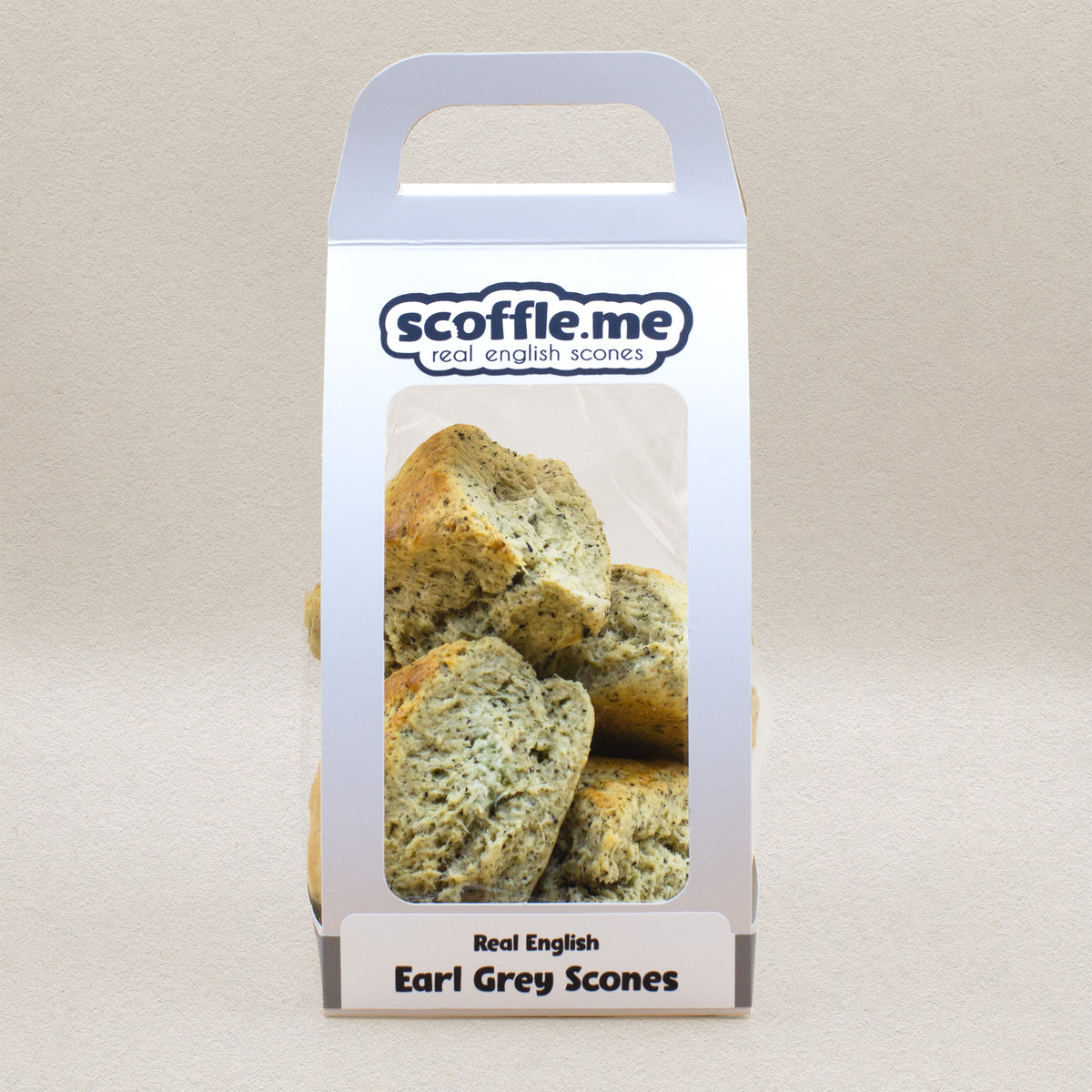 A cute white handled bag showcasing four delicious rustic scones infused with real Earl Grey tea.