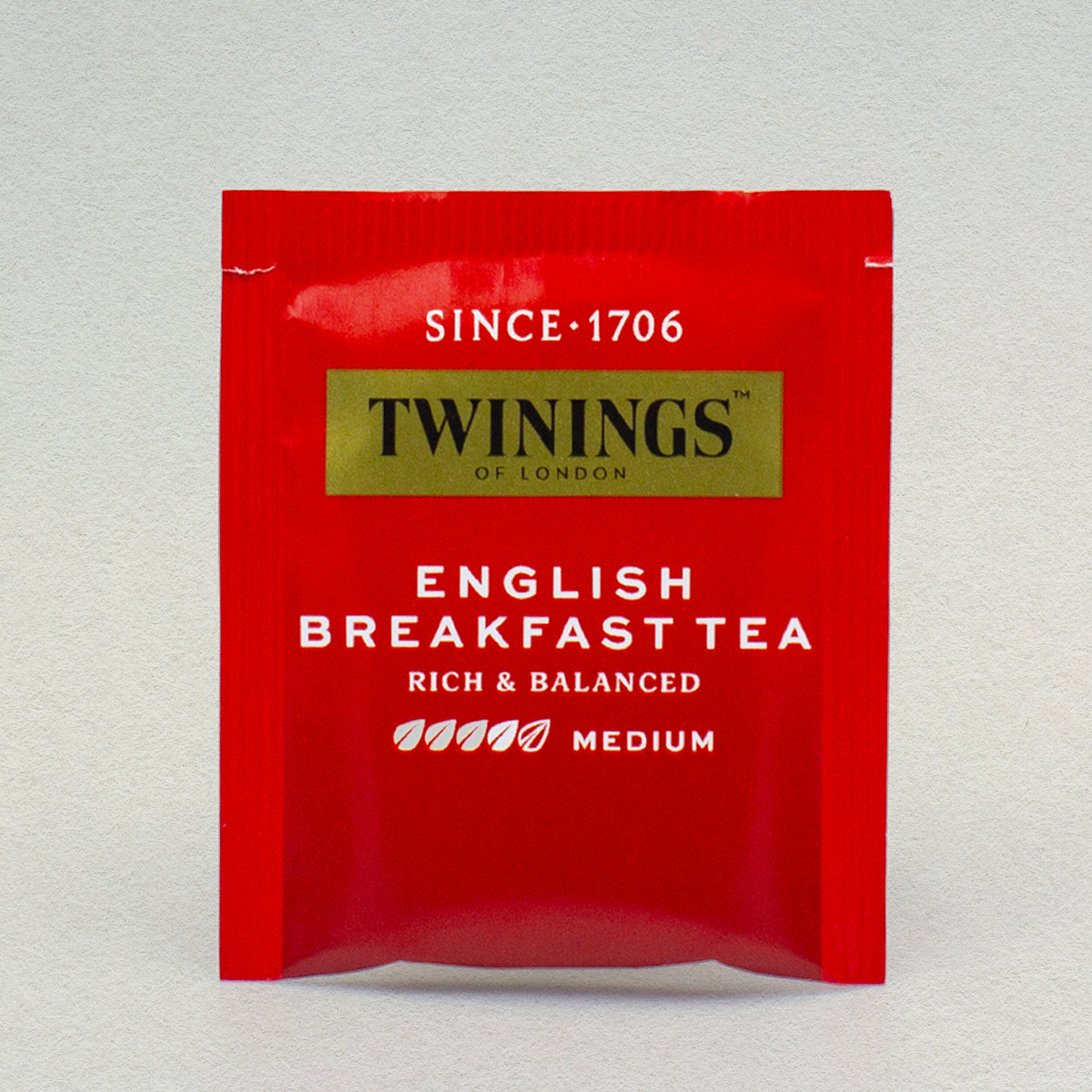 A single Twinings Pure English Breakfast tea bag in its packaging.
