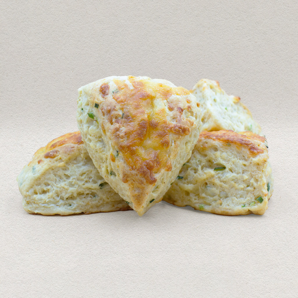 Four golden brown savory English scones baked with cheddar cheese and chives. 