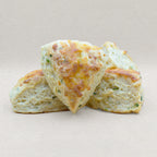 Four golden brown savory English scones baked with cheddar cheese and chives. 