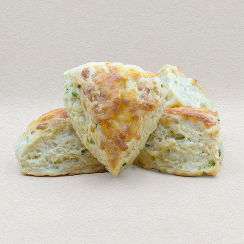 Four golden brown savory English scones baked with cheddar cheese and chives. 