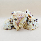 Four delicious fluffy cranberry scones with a golden crust.