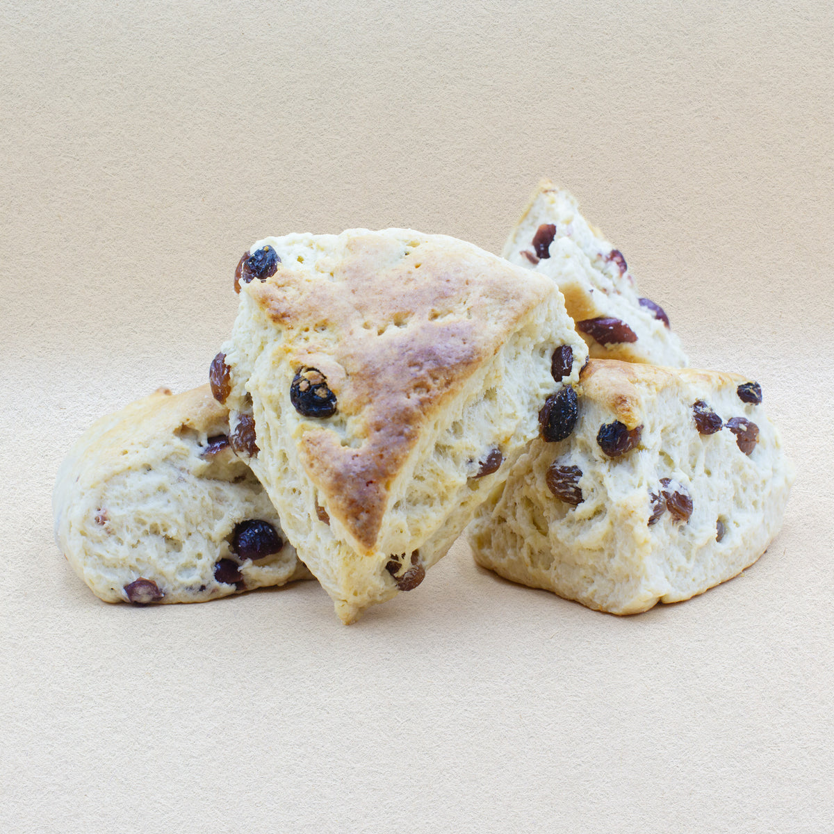 Four delicious fluffy cranberry scones with a golden crust.