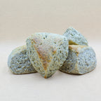 Four delicious English scones infused with Earl Grey tea. Specks of real tea are visible throughout the fluffy triangular scones. 