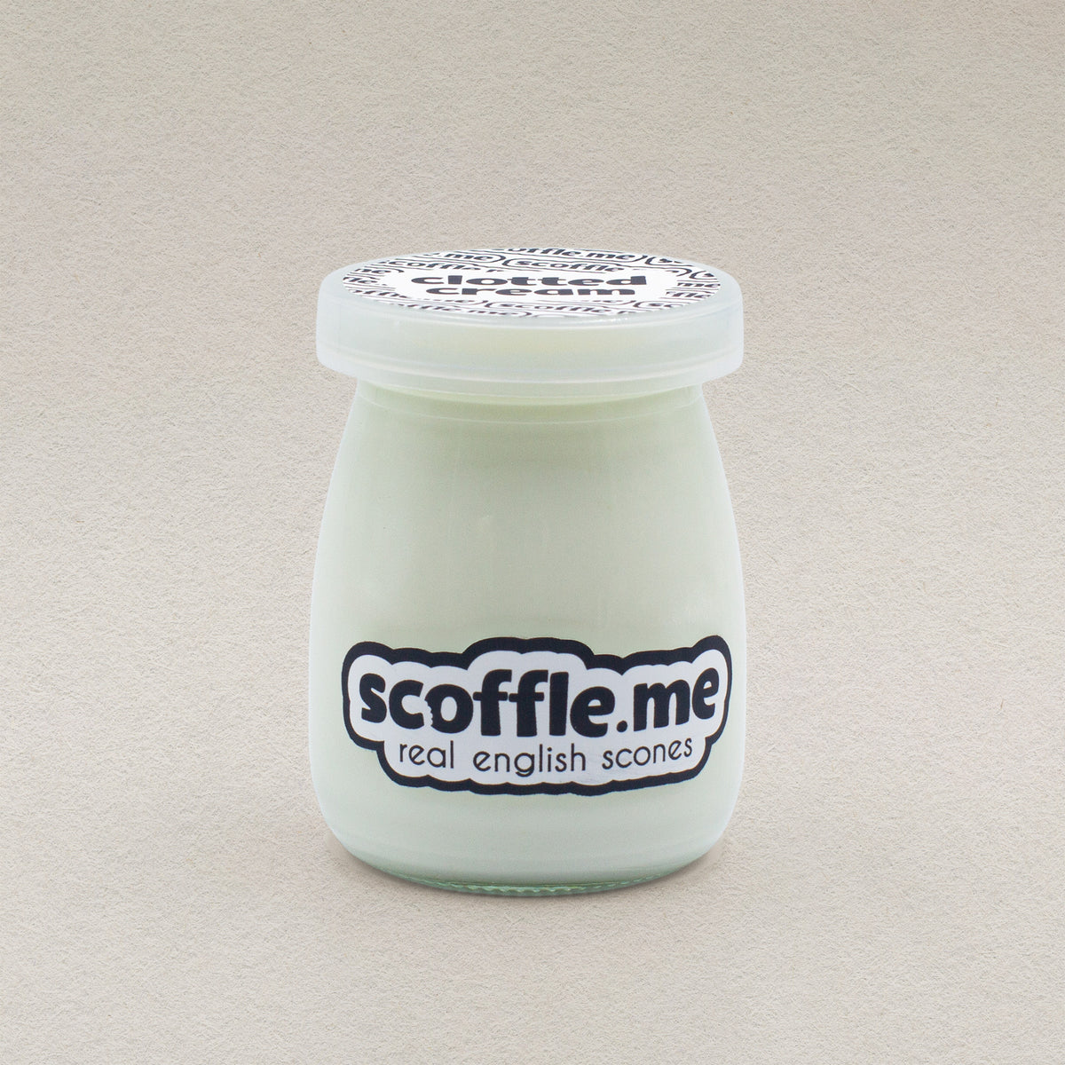 A retro looking 100ml glass jar of Scoffle Me branded homemade clotted cream.