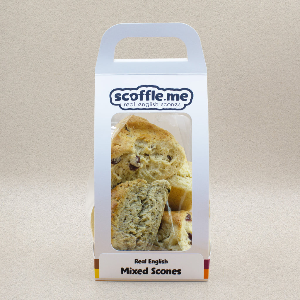 A cute white branded cardboard carrier with a handle and a clear display window showcasing four different flavoured scones.
