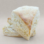 Two fluffy plain traditional English scones with a delightful golden crust.