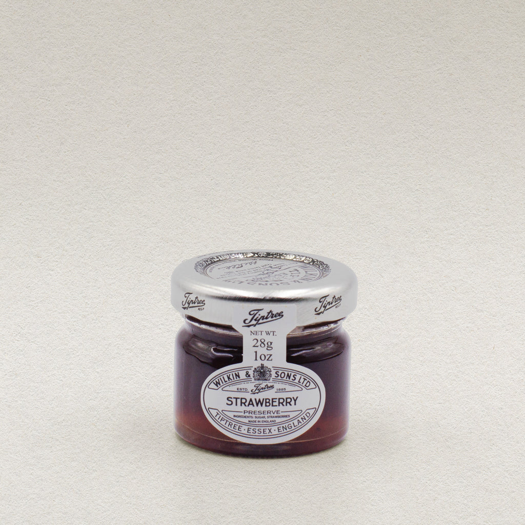 A 28g glass jar of Wilkin & Sons strawberry jam.